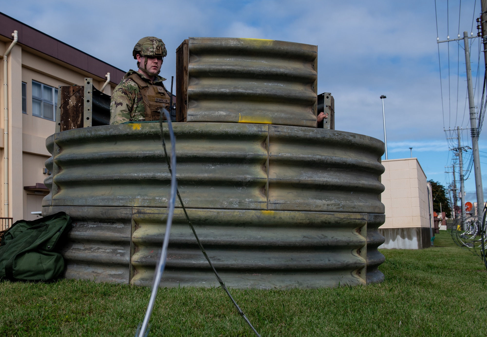An Airman stands in the defensive fighting position