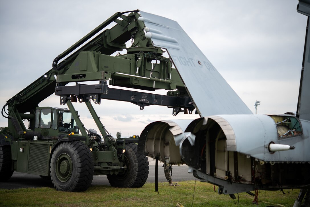 A U.S. Marine Corps rough terrain container handler with Marine Wing Support Squadron 171, Marine Aircraft Group 12, 1st Marine Air Wing, prepares to lift a simulated damaged F/A-18 Hornet aircraft recovery during exercise Keen Sword 25 at Marine Corps Air Station Iwakuni, Japan, Oct. 31, 2024. Keen Sword is a biennial, joint and bilateral field-training exercise involving U.S. military and Japan Self-Defense Force personnel, designed to increase readiness and interoperability while strengthening the ironclad U.S.-Japan alliance. (U.S. Marine Corps photo by Lance Cpl. Madison Sharpe)