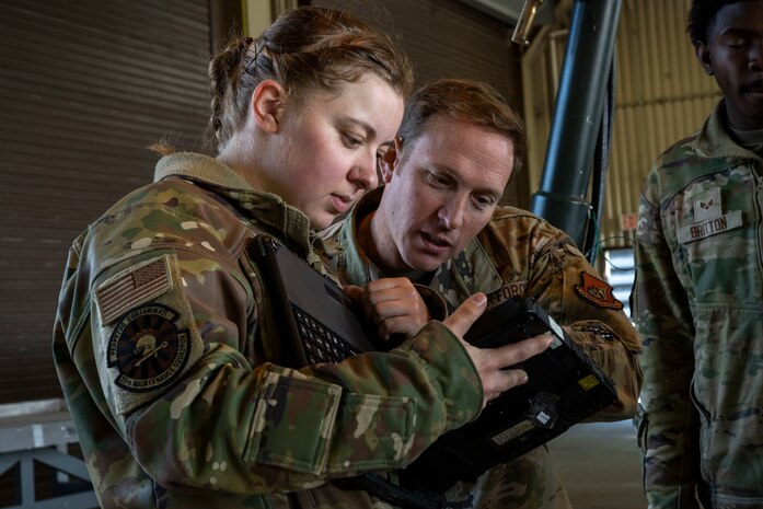 U.S. Air Force Col. Paul Davidson, right, 35th Fighter Wing commander, and U.S. Air Force Staff Sgt. Julia Danke-Garcia, 35th Maintenance Squadron Munitions Flight conventional munitions crew chief, examine notes.