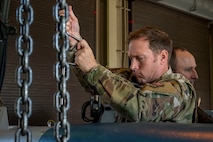 U.S. Air Force Col. Paul Davidson, 35th Fighter Wing commander, assembles an inert GBU-38 bomb.
