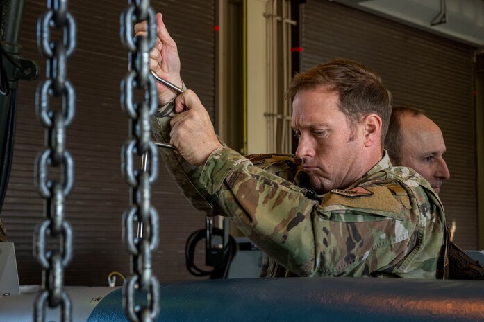 U.S. Air Force Col. Paul Davidson, 35th Fighter Wing commander, assembles an inert GBU-38 bomb.