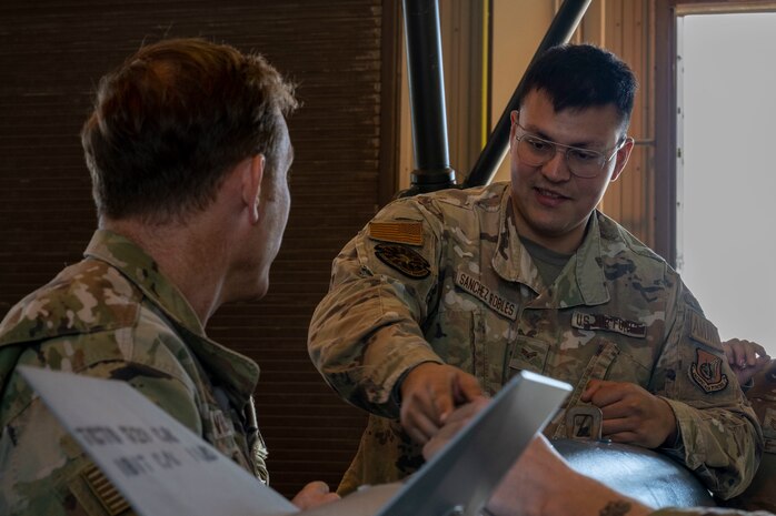 U.S. Air Force Senior Airman Victor Sanchez-Robles, 35th Maintenance Squadron Munitions Flight conventional munitions crew chief, explains bomb assembly to Col. Paul Davidson, 35th Fighter Wing commander.
