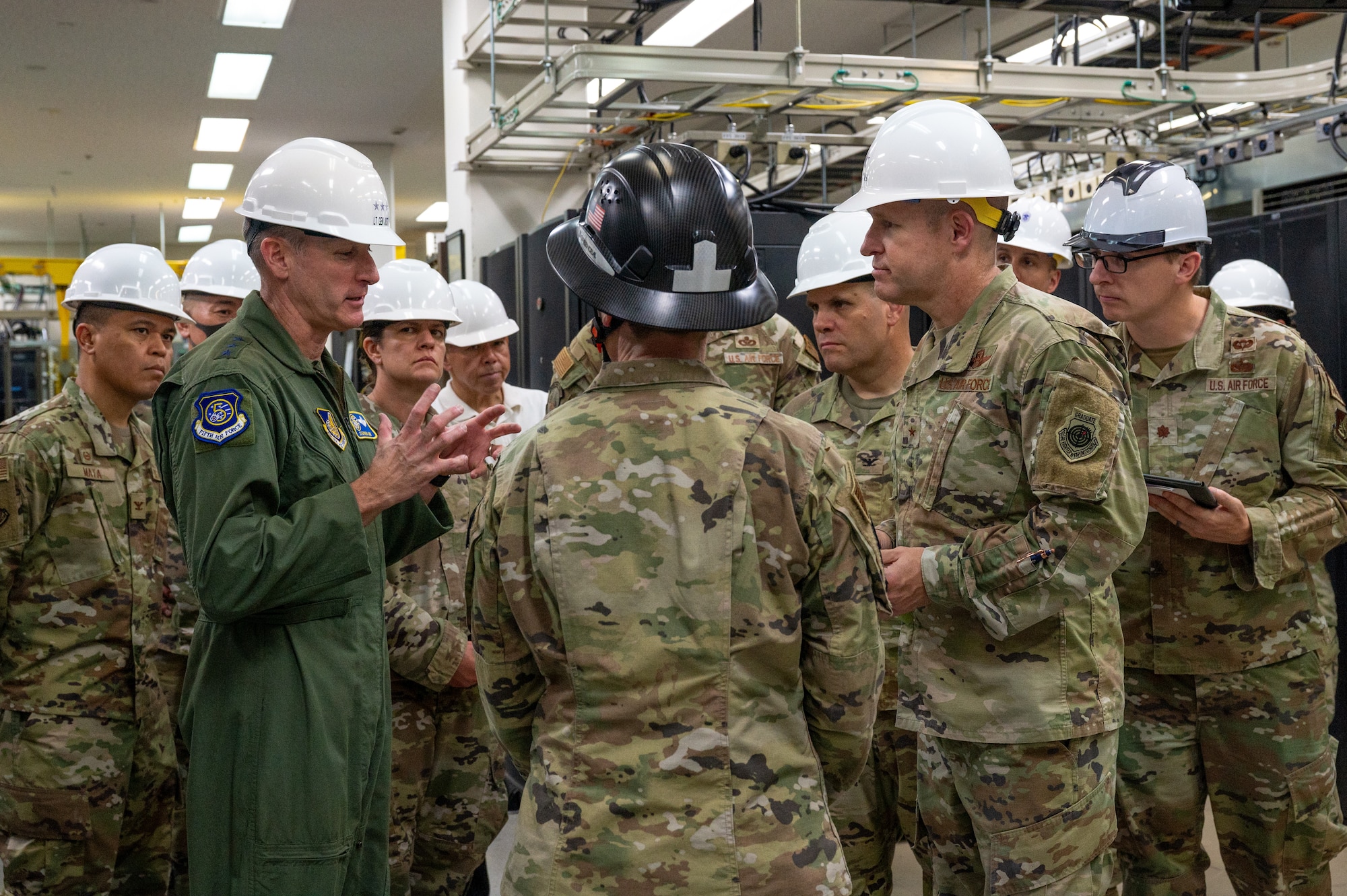 Military members stand inside the building on the communication squadron
