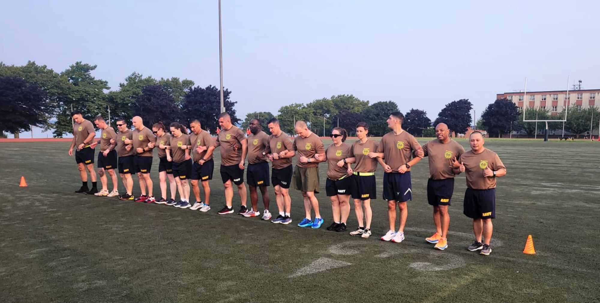 U.S. Navy Senior Enlisted Academy class 276, Green Horizon, link arms in preparation for a physical training exercise, August, 2024.