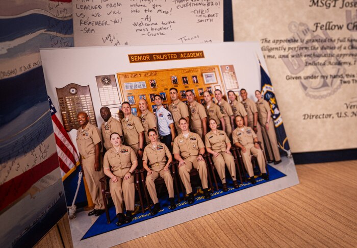 A photograph of the U.S. Navy Senior Enlisted Academy Class 276, Green Horizon, rests on a desk at Royal Air Force Mildenhall, England, Oct. 22, 2024.
