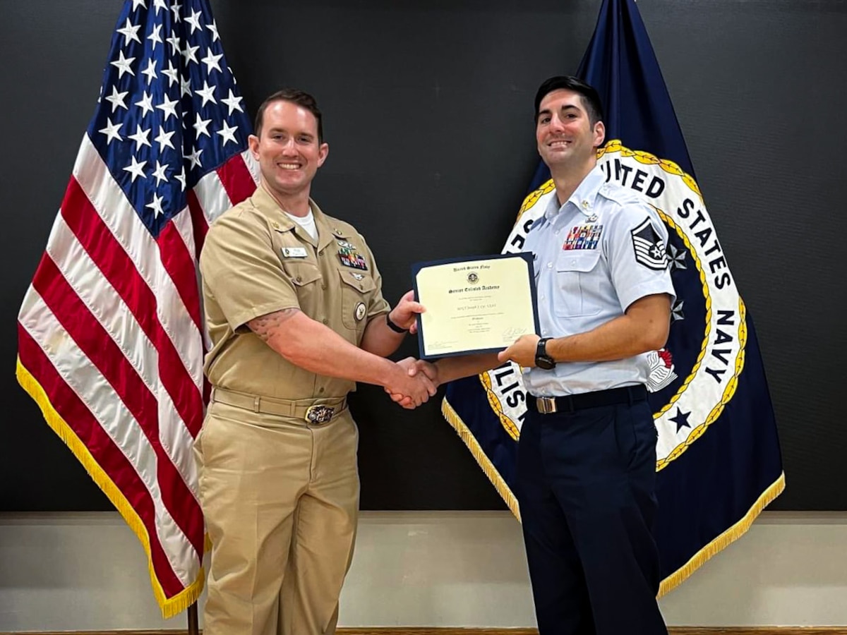 U.S. Air Force Master Sgt. Joseph Cyr, 100th Operations Support Squadron Aircrew Flight Equipment superintendent, receives a certificate for completing his professional military education course at the U.S. Navy Senior Enlisted Academy, Newport, Rhode Island, August 29, 2024.