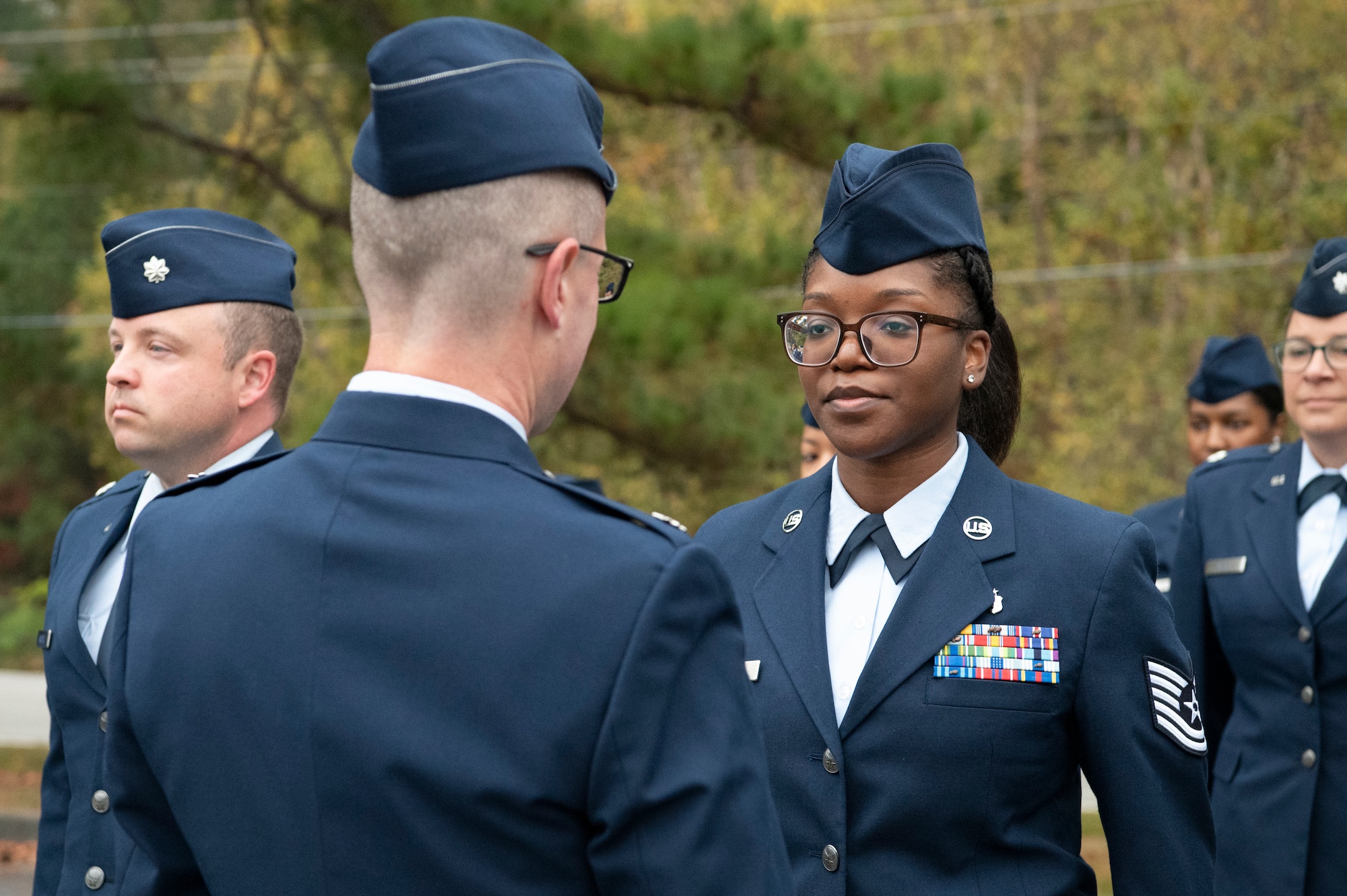 A man inspects a service dress uniform.