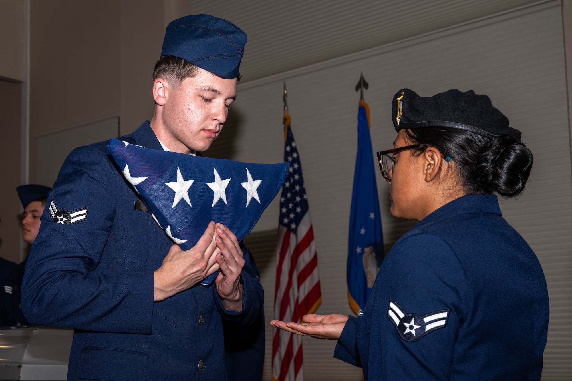 Seymour Johnson Air Force Base Honor Guard graduates demonstrate a six-man flag-fold during an honor guard graduation ceremony at Seymour Johnson Air Force Base.