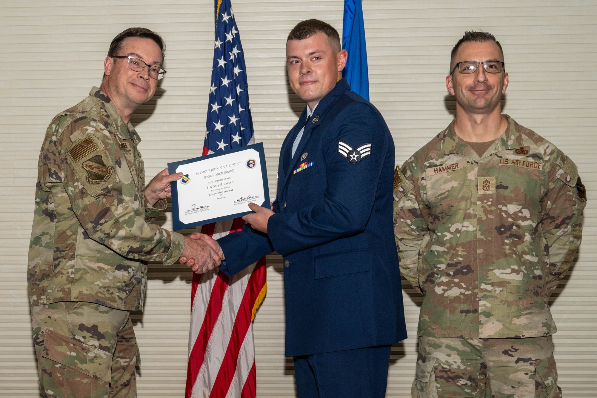 Col. Richard Boatman, left, 4th Maintenance Group commander, and Chief Master Sgt. Paul Hammer, 4th Fighter Wing command chief, presents a “Leadership” certificate to Senior Airman Gary Larsen.