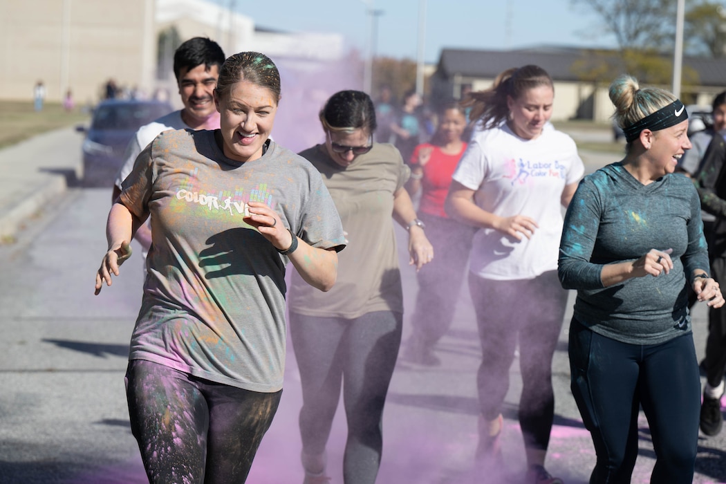 Members of Team Dover run through a cloud of powder during a color run at Dover Air Force Base, Delaware, Oct. 18, 2024. This year’s run was hosted by the Dover AFB Sexual Assault Prevention and Response team and the Family Advocacy Program to bring awareness and prevention to sexual assault and domestic violence. The annual run raises attention to the signs of assault and violence, and the agencies that are geared to help Airmen and their families. (U.S. Air Force photo by Mauricio Campino)