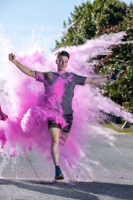 U.S. Air Force 1st Lt. Henry Leighton, 436th Medical Group medical readiness officer, gets blasted with powder during a color run at Dover Air Force Base, Delaware, Oct. 18, 2024. This year’s run was hosted by the Dover AFB Sexual Assault Prevention and Response team and the Family Advocacy Program to bring awareness and prevention to sexual assault and domestic violence. The annual run raises attention to the signs of assault and violence, and the agencies that are geared to help Airmen and their families. (U.S. Air Force photo by Mauricio Campino)