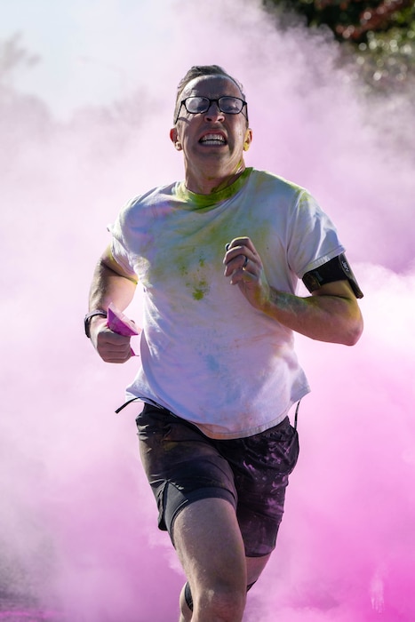 U.S. Air Force 1st Lt. Ronald Gogan, 436th Wing Staff Agency chaplain, runs through a cloud of powder during a color run at Dover Air Force Base, Delaware, Oct. 18, 2024. This year’s run was hosted by the Dover AFB Sexual Assault Prevention and Response team and the Family Advocacy Program to bring awareness and prevention to sexual assault and domestic violence. The annual run raises attention to the signs of assault and violence, and the agencies that are geared to help Airmen and their families. (U.S. Air Force photo by Mauricio Campino)