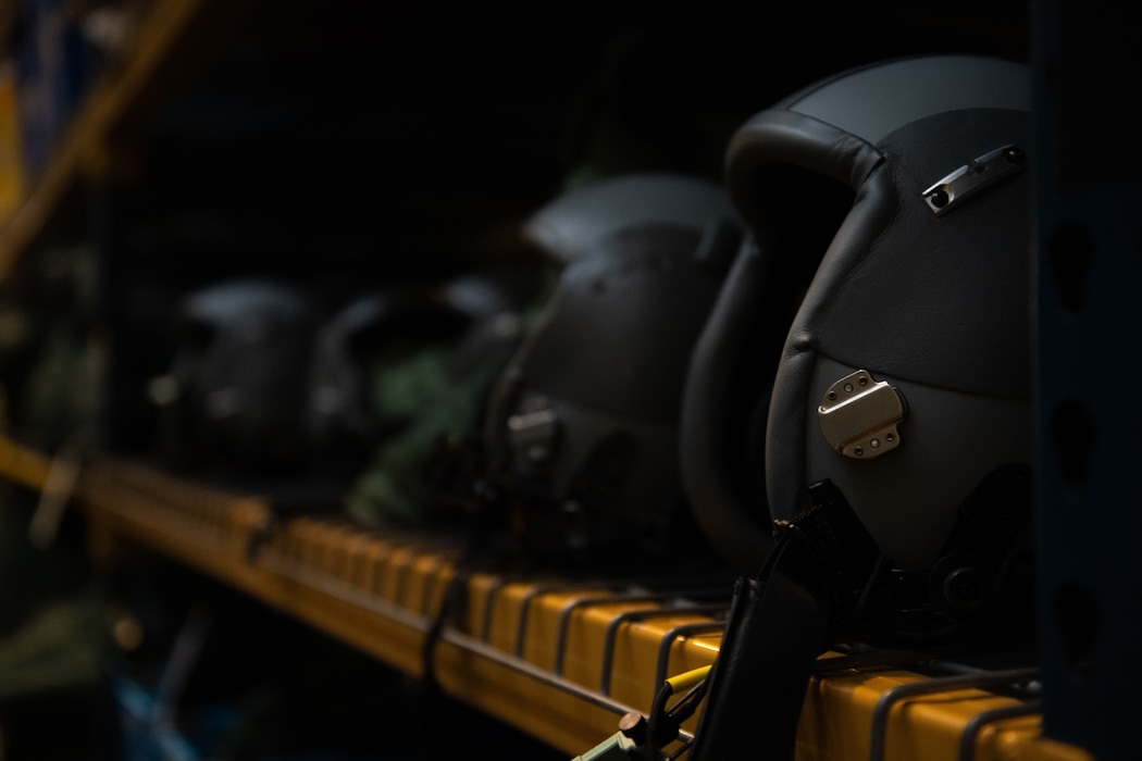 Helmets sit on a shelf at the 436th Operation Support Squadron Aircrew Flight Equipment warehouse at Dover Air Force Base, Delaware, Oct. 29, 2024. The AFE team provides inspections and maintenance for flight safety equipment such as parachutes, emergency escape slides and life rafts for the C-5M Super Galaxy and C-17 Globemaster III. (U.S. Air Force photo by Airman 1st Class Liberty Matthews)