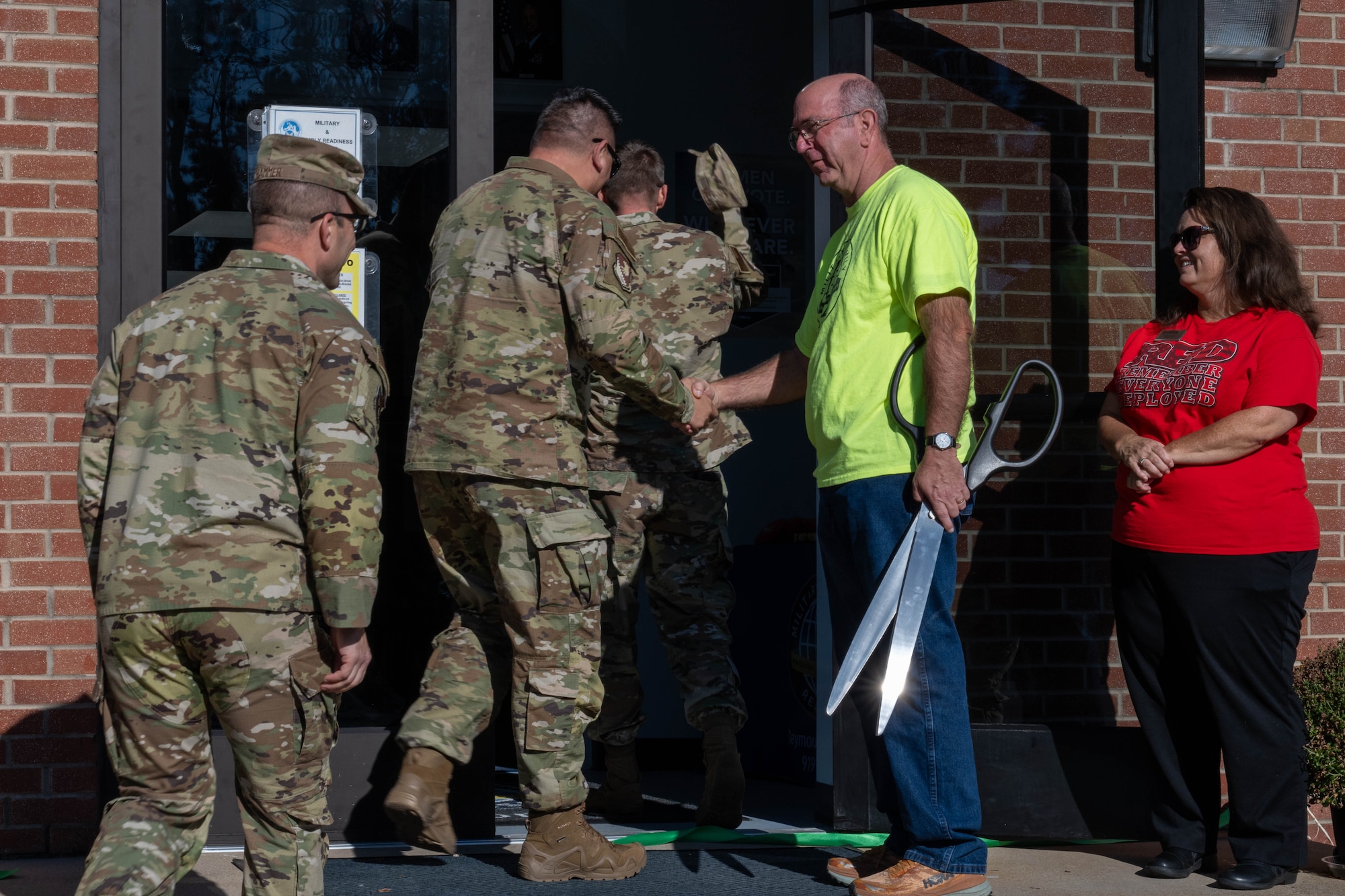 Military and Family Readiness Center personnel greet base leadership as they enter the new facility.