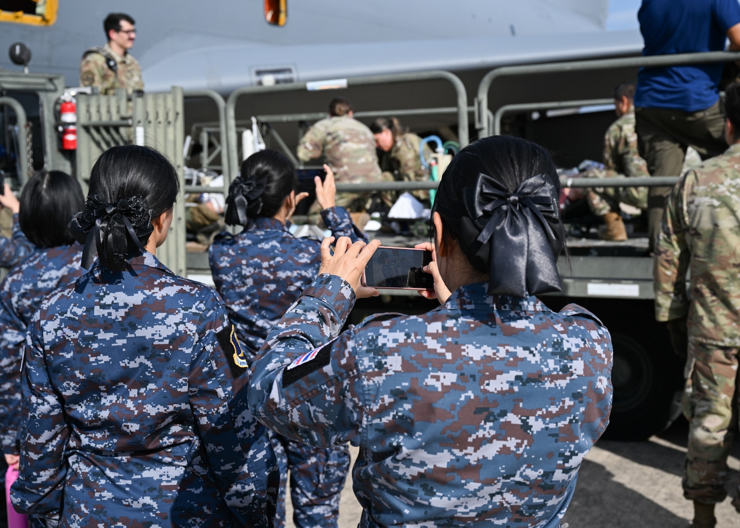 Royal Thai Air Force nurses observe medical training on the flight line at Kelly Airfield, Sept. 9, 2024.