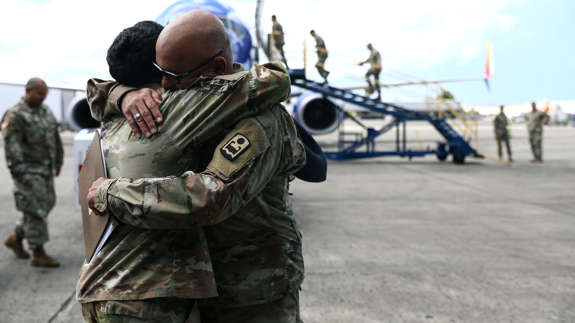 U.S. Sgt. Hassani Ribera assigned to the 113th Mobile Public Affairs Detachment, 101st Troop Command, and 1st Sgt. Jorge Ribera of the 755th Military Police Company, 92nd military Police Brigade, Puerto Rico Army National Guard, hug and say goodbye at Luis Muñoz Marín International Airport, San Juan, Puerto Rico, Nov. 3, 2024.