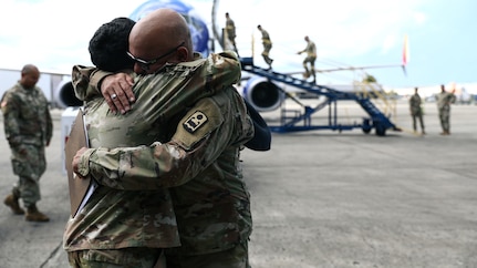 U.S. Sgt. Hassani Ribera assigned to the 113th Mobile Public Affairs Detachment, 101st Troop Command, and 1st Sgt. Jorge Ribera of the 755th Military Police Company, 92nd military Police Brigade, Puerto Rico Army National Guard, hug and say goodbye at Luis Muñoz Marín International Airport, San Juan, Puerto Rico, Nov. 3, 2024.