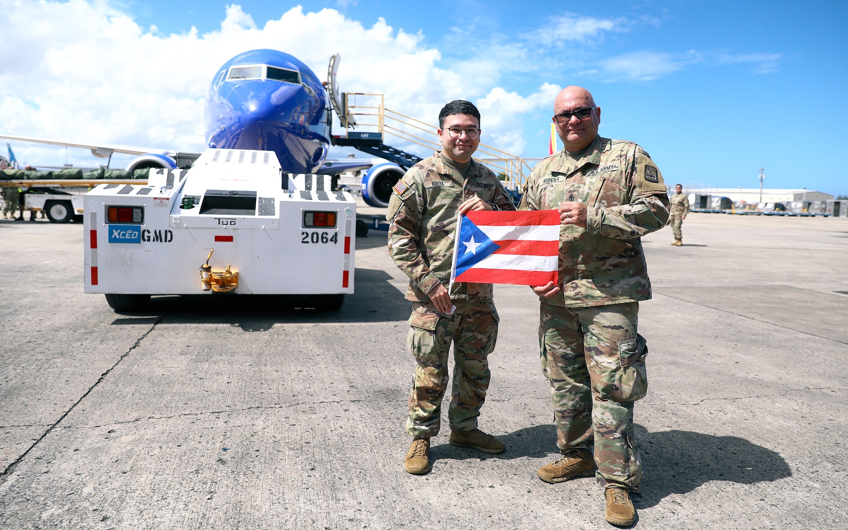 U.S. Sgt. Hassani Ribera assigned to the 113th Mobile Public Affairs Detachment, 101st Troop Command, and 1st Sgt. Jorge Ribera of the 755th Military Police Company, 92nd military Police Brigade, Puerto Rico Army National Guard, pose for a photo at Luis Muñoz Marín International Airport, San Juan, Puerto Rico, Nov. 3, 2024.