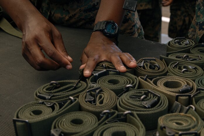 A U.S. Marines with India Company, 3rd Recruit Training Battalion, organizes rifle slings during a M16A4 service rifle de-issue at Marine Corps Recruit Depot San Diego, California, Oct. 23, 2024. After carrying their rifles throughout recruit training the new Marines will properly clean and de-issue their rifles to extend the life of the rifles and allow more time to maintain them for future recruits. (U.S. Marine Corps photo by Cpl. Sarah M. Grawcock)