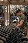 U.S. Marine Corps Lance Cpl. Payton Hubbard, a small arms repair technician, with Headquarters and Service Battalion, inspects Marines with India Company, 3rd Recruit Training Battalion, rifles during a M16A4 service rifle de-issue at Marine Corps Recruit Depot San Diego, California, Oct. 23, 2024. After carrying their rifles throughout recruit training the new Marines will properly clean and de-issue their rifles to extend the life of the rifles and allow more time to maintain them for future recruits. (U.S. Marine Corps photo by Cpl. Sarah M. Grawcock)