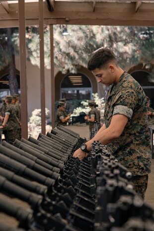 U.S. Marine Corps Lance Cpl. Payton Hubbard, a small arms repair technician, with Headquarters and Service Battalion, inspects Marines with India Company, 3rd Recruit Training Battalion, rifles during a M16A4 service rifle de-issue at Marine Corps Recruit Depot San Diego, California, Oct. 23, 2024. After carrying their rifles throughout recruit training the new Marines will properly clean and de-issue their rifles to extend the life of the rifles and allow more time to maintain them for future recruits. (U.S. Marine Corps photo by Cpl. Sarah M. Grawcock)