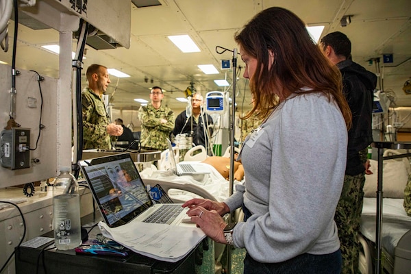 241017-N-KC192-1004 NORFOLK, Va. (Oct. 17, 2024) Liz Sheridan, a Senior Territory Manager with Laerdal Medical, programs a simulation manikin during dental officer triage training aboard the Wasp-class amphibious assault ship USS Iwo Jima (LHD 7), Oct. 17, 2024. Over the course of three days, Army and Navy dental officers from Iwo Jima, Navy Medicine Readiness and Training Command (NMRTC) Portsmouth and Fort Gregg-Adams Dental Clinic Command conducted mass casualty, tactical combat casualty care, and triage training. (U.S. Navy photo by Mass Communication Specialist 2nd Class Levi Decker)