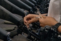 A U.S. Marine with India Company, 3rd Recruit Training Battalion, cleans a rifle during a M16A4 service rifle de-issue at Marine Corps Recruit Depot San Diego, California, Oct. 23, 2024. After carrying their rifles throughout recruit training the new Marines will properly clean and de-issue their rifles to extend the life of the rifles and allow more time to maintain them for future recruits. (U.S. Marine Corps photo by Cpl. Sarah M. Grawcock)