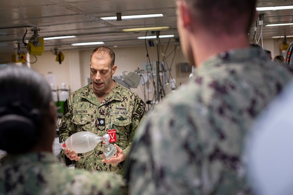 241017-N-KC192-1039 NORFOLK, Va. (Oct. 17, 2024) Cmdr. Peter Cervenka, an oral and maxillofacial surgeon assigned to Navy Medicine Readiness and Training Command (NMRTC) Portsmouth, demonstrates use of assisted breathing apparatuses during dental officer triage training aboard the Wasp-class amphibious assault ship USS Iwo Jima (LHD 7), Oct. 17, 2024. Over the course of three days, Army and Navy dental officers from Iwo Jima, NMRTC Portsmouth and Fort Gregg-Adams Dental Clinic Command conducted mass casualty, tactical combat casualty care, and triage training. (U.S. Navy photo by Mass Communication Specialist 2nd Class Levi Decker)