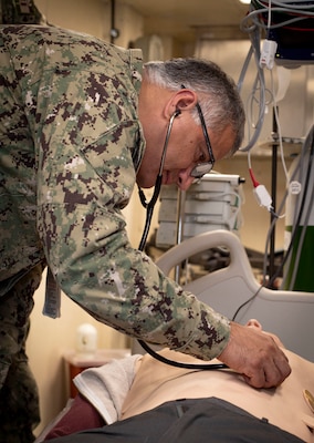 241017-N-KC192-1075 NORFOLK, Va. (Oct. 17, 2024) Capt. Jose Pedroza, the regional senior dental officer assigned to Naval Medical Forces Atlantic (NMFL), uses a stethoscope to examine a simulation manikin during dental officer triage training aboard the Wasp-class amphibious assault ship USS Iwo Jima (LHD 7), Oct. 17, 2024. Over the course of three days, Army and Navy dental officers from Iwo Jima, Navy Medicine Readiness and Training Command (NMRTC) Portsmouth and Fort Gregg-Adams Dental Clinic Command conducted mass casualty, tactical combat casualty care, and triage training. (U.S. Navy photo by Mass Communication Specialist 2nd Class Levi Decker)