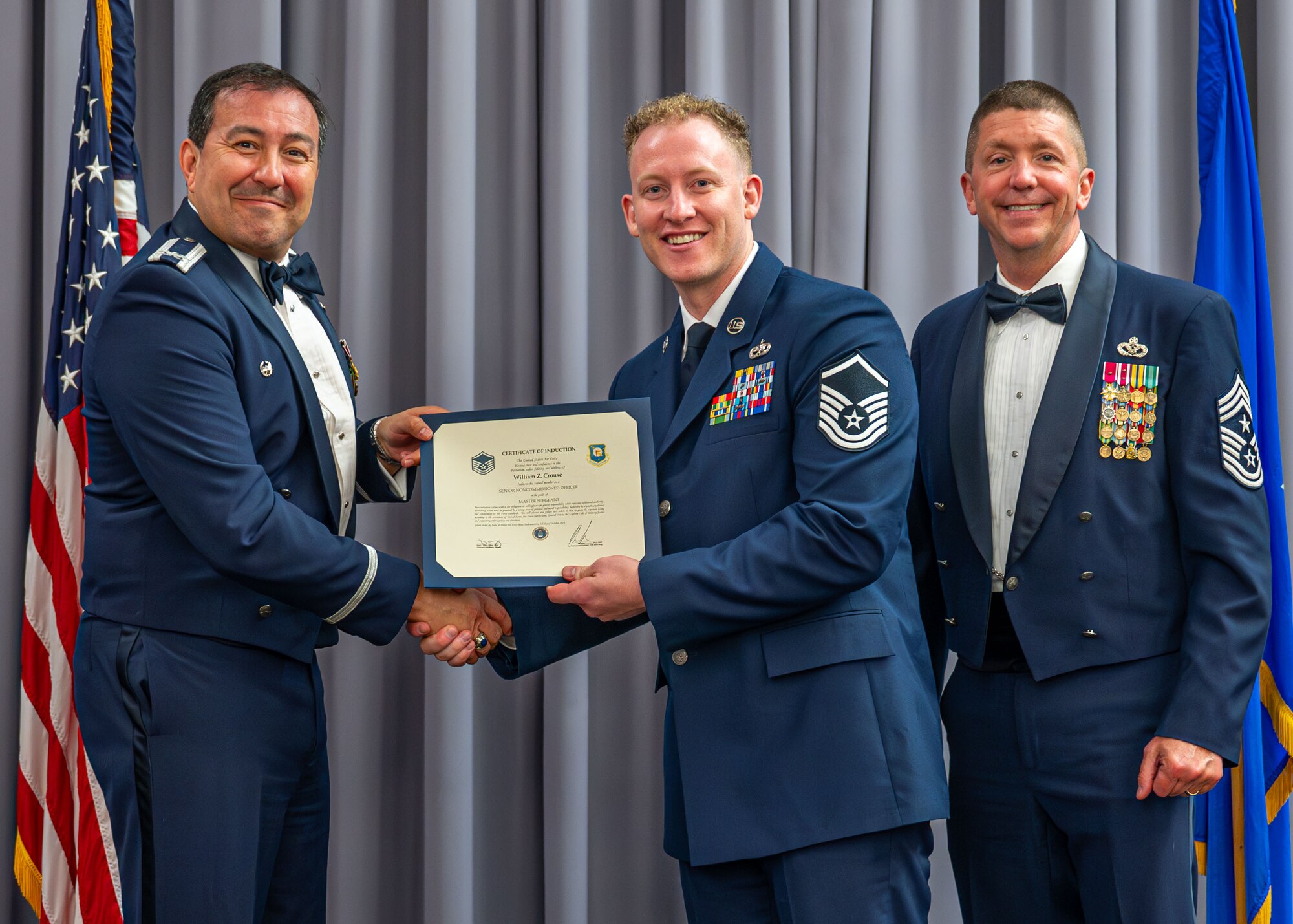 Commander presents certificate of induction