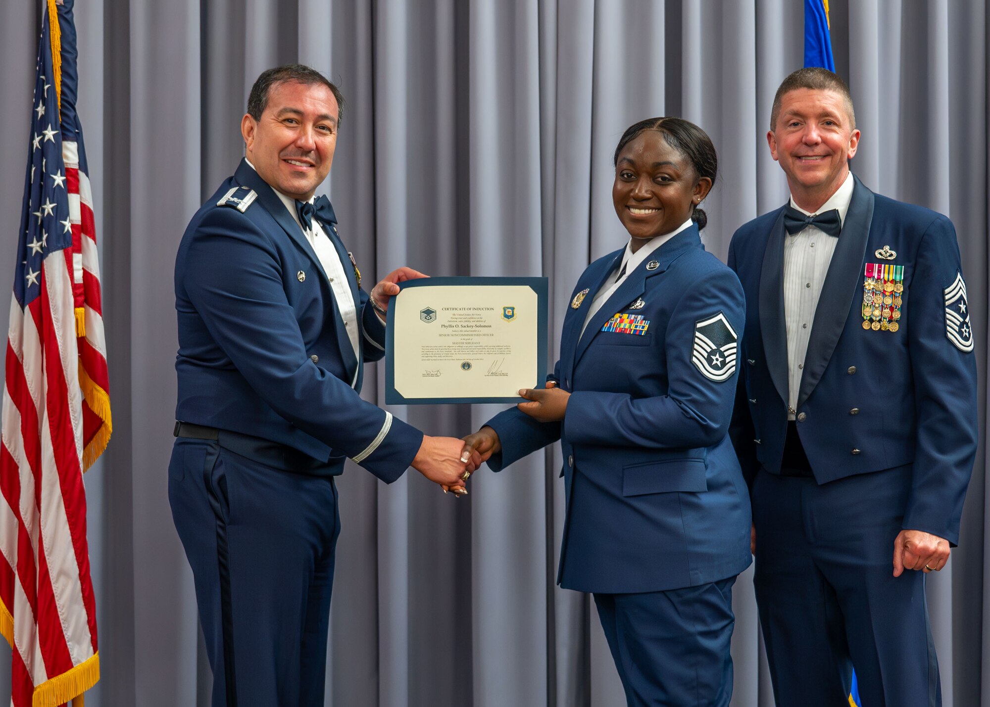 Commander presents certificate of induction