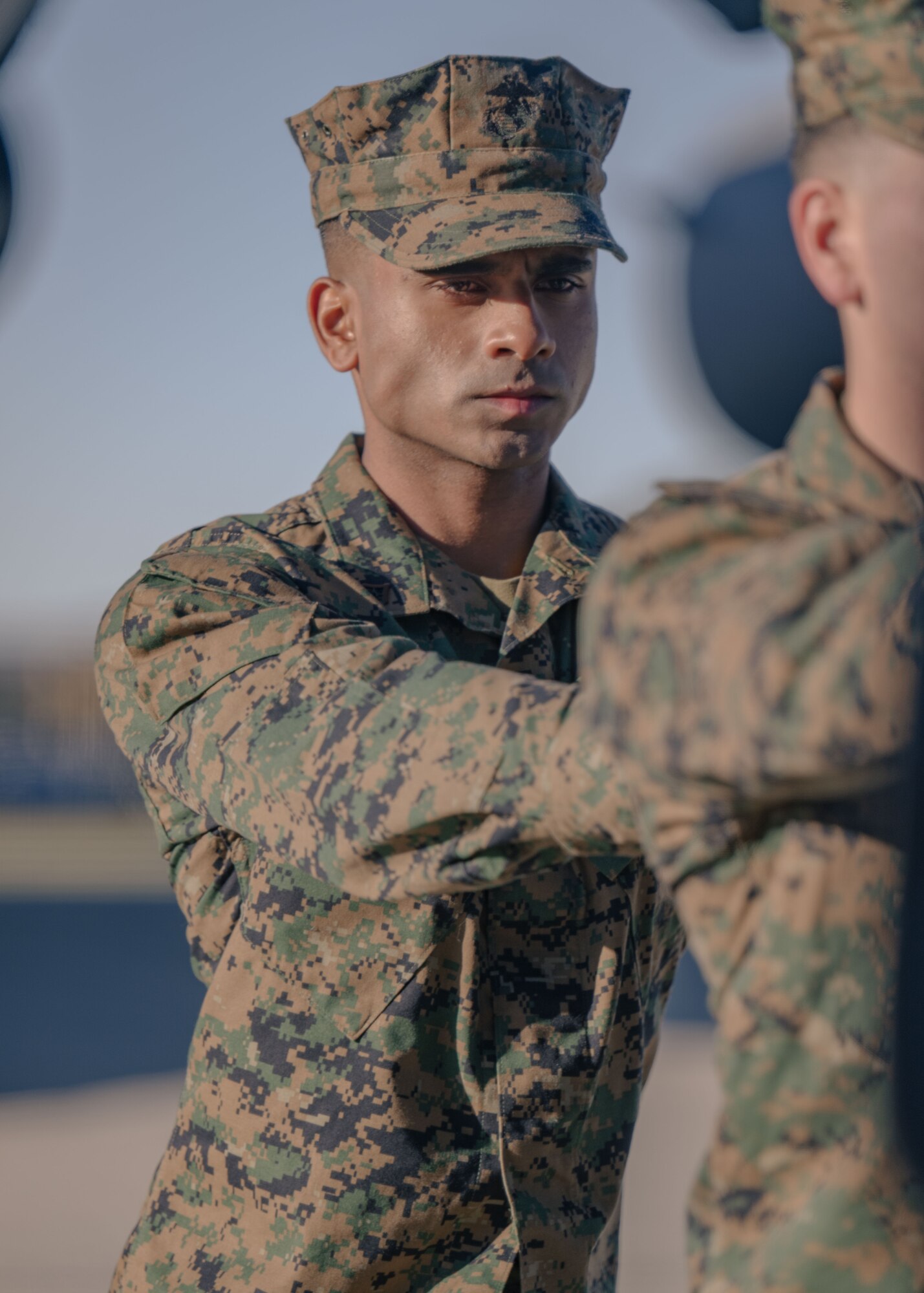 A Marine waits as another Marine secures a transfer case inside a transfer vehicle during a dignified transfer ground training.