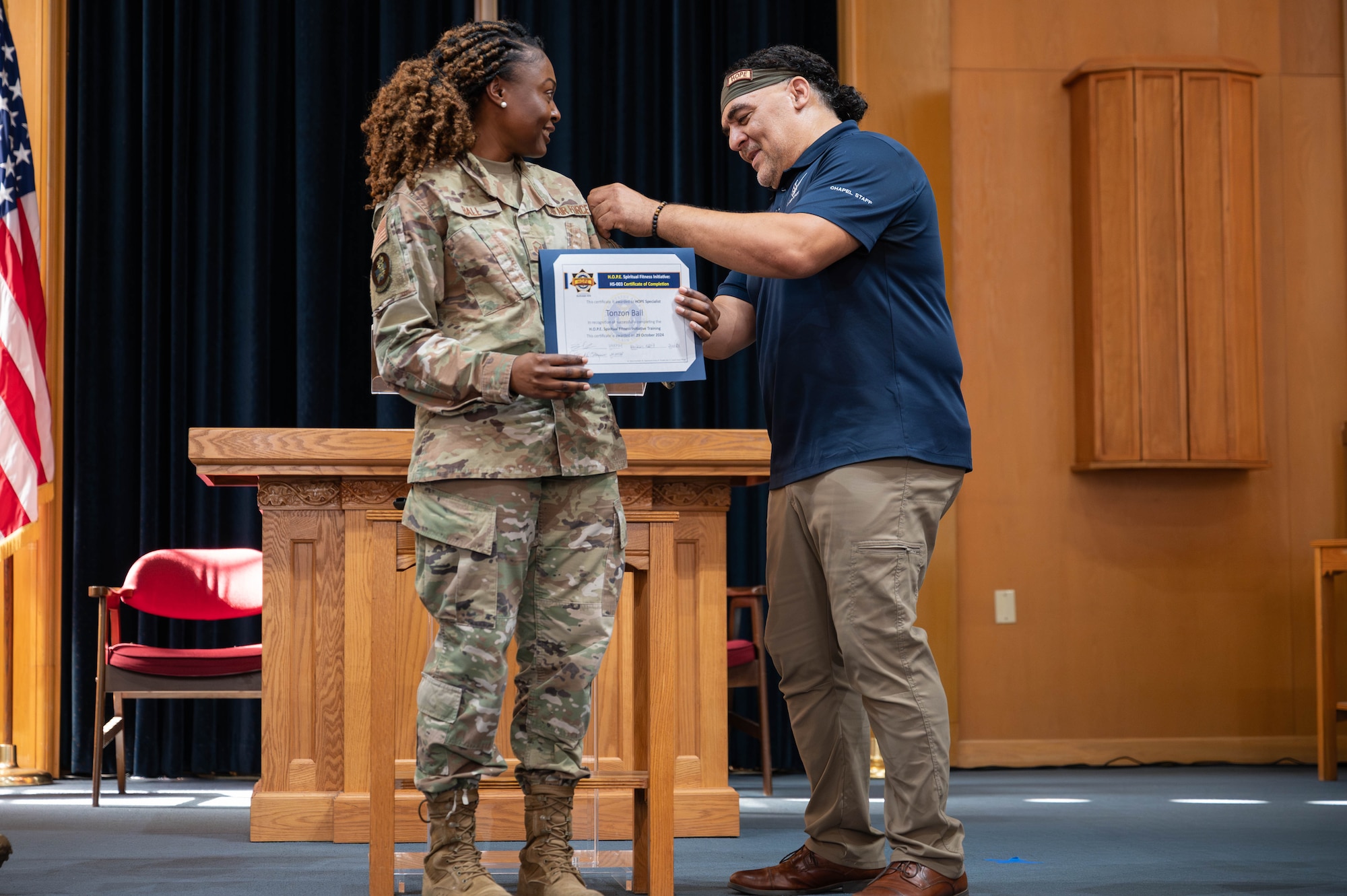 Airman 1st Class Shakaylen Moore receives her HOPE tab from Patrick Catanese.