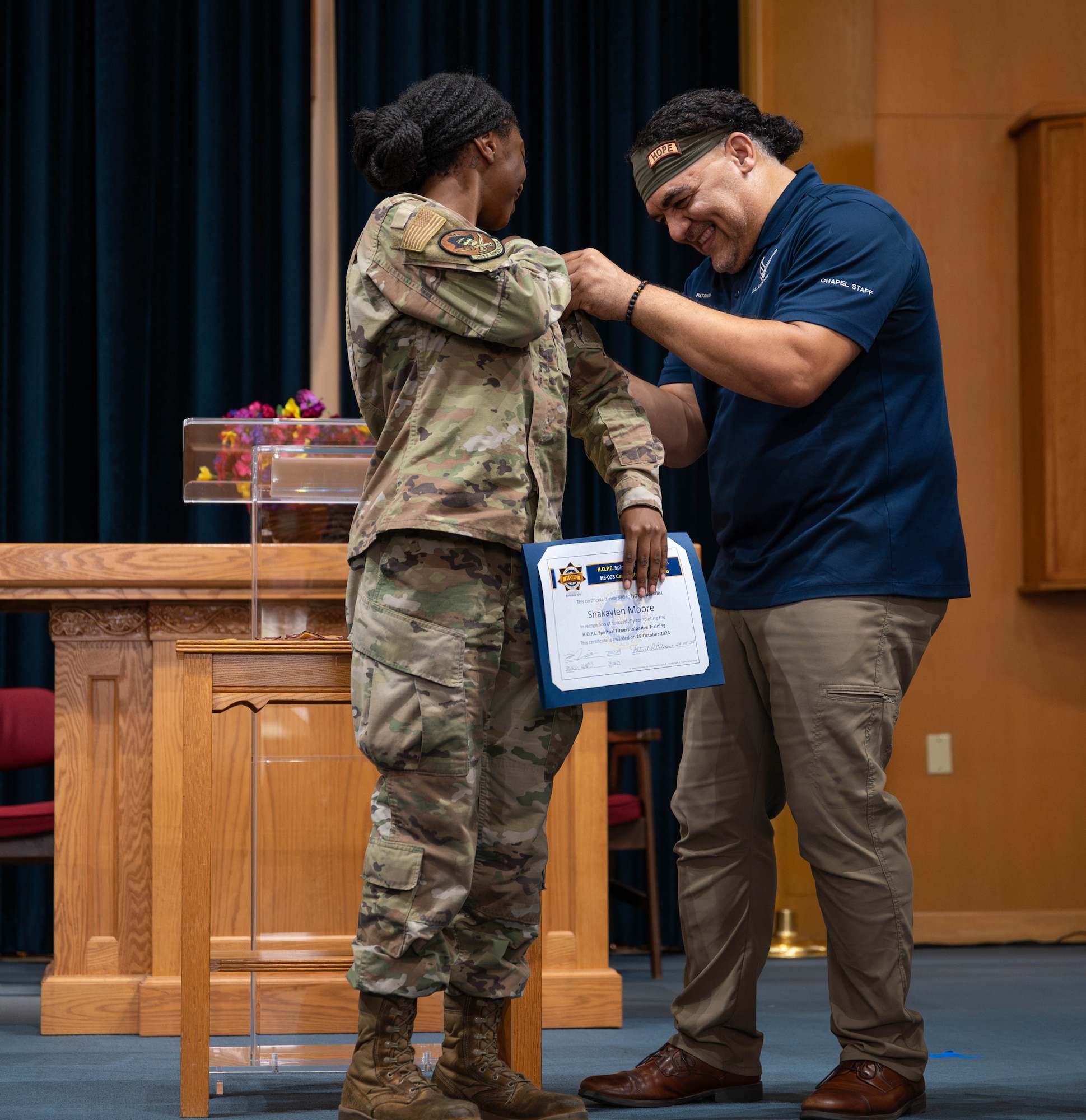 Airman 1st Class Shakaylen Moore receives her HOPE tab from Patrick Catanese.