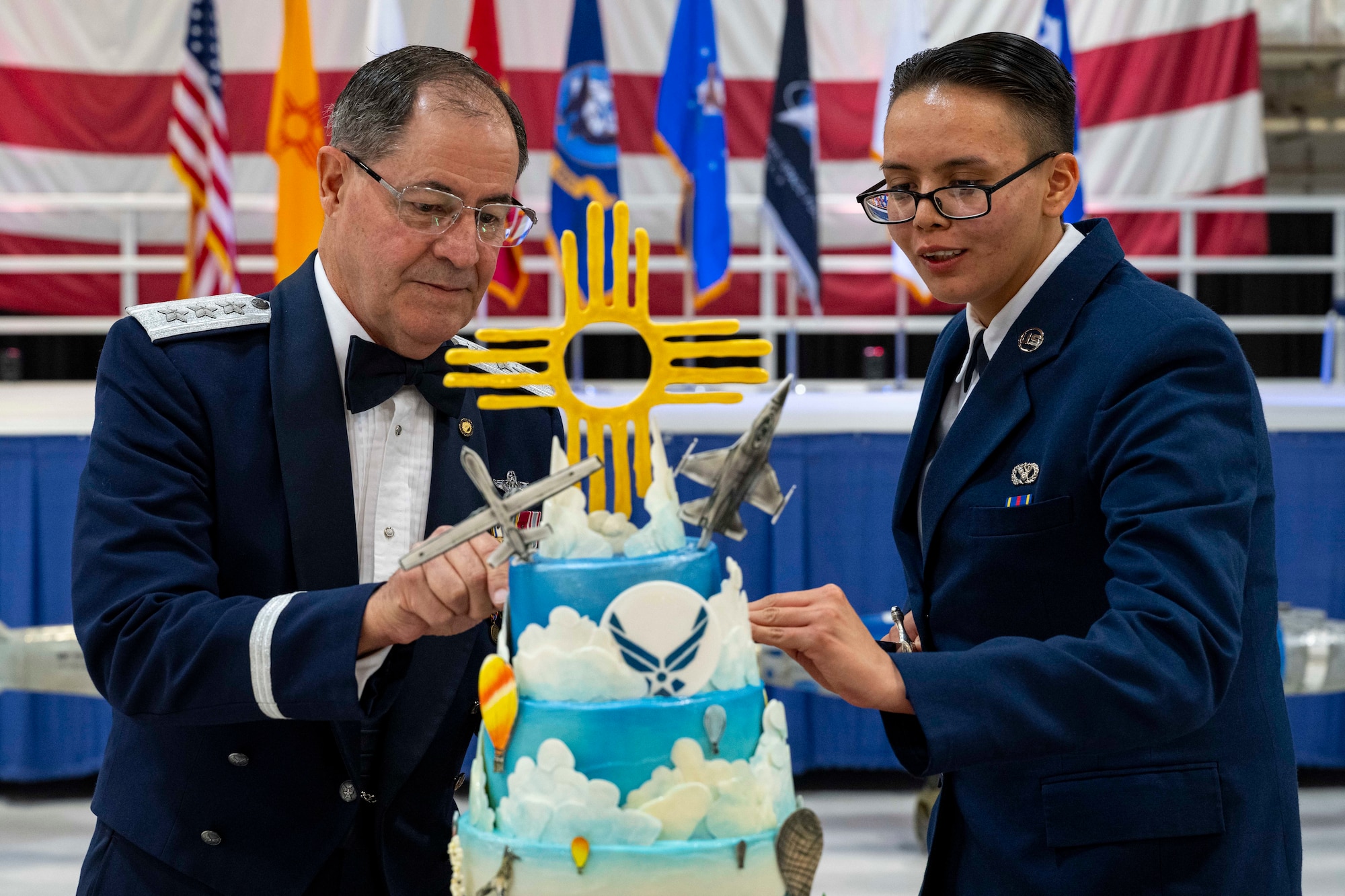 Retired U.S. Air Force Lt. Gen. Marc Rogers, Inspector General of the Air Force, left, and U.S. Air Force Airman Chelsea Timentwa, 635th Materiel Maintenance Squadron command support section technician, cut the cake during the 2024 Holloman Air Force Ball at Holloman Air Force Base, New Mexico, Nov. 2, 2024.