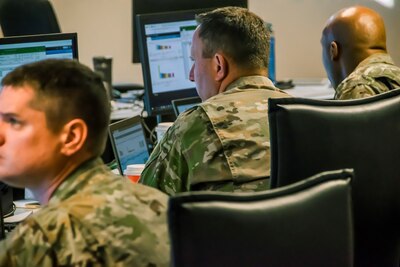 Members of the Colorado National Guard's Task Force Cyber help Colorado Secretary of State Wayne W. Williams monitor network traffic and advise the Chief Information Officer Trevor Timmons Nov. 6, 2018. (U.S. Air National Guard Photo by Maj. Darin Overstreet)