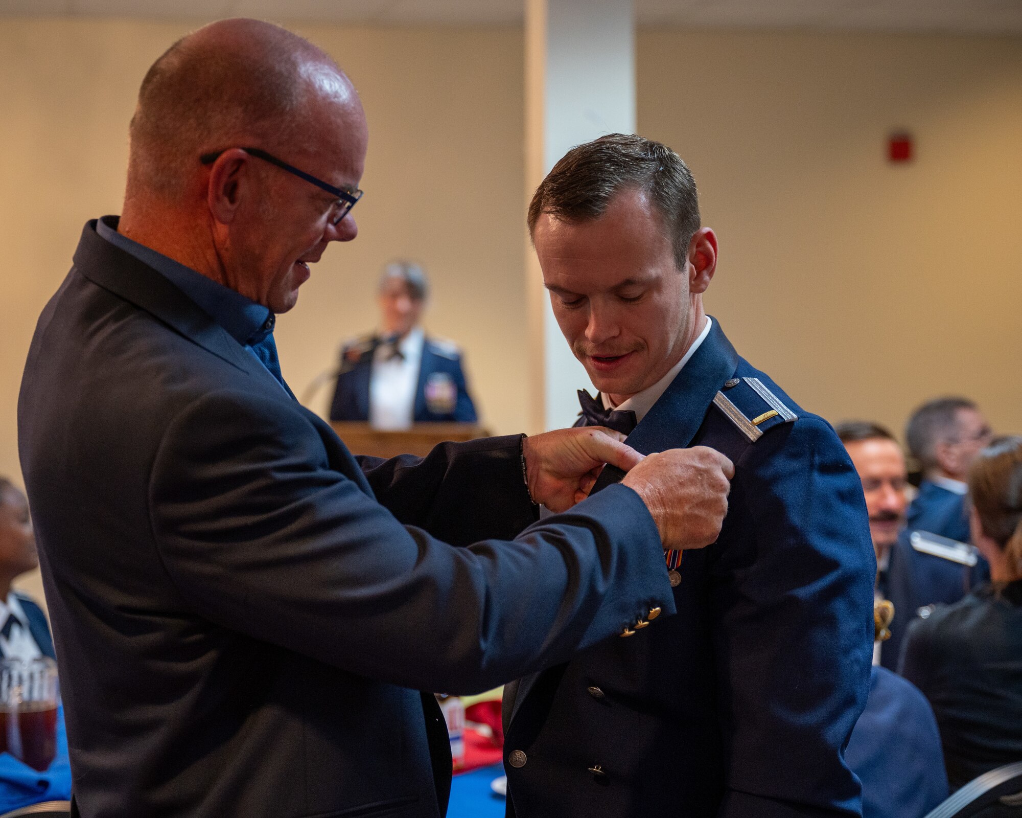 A family member pins the wings on a recently graduated pilot at Laughlin Air Force Base, Texas, Nov. 1, 2024. (U.S. Air Force photo by Staff Sgt. Nicholas Larsen)