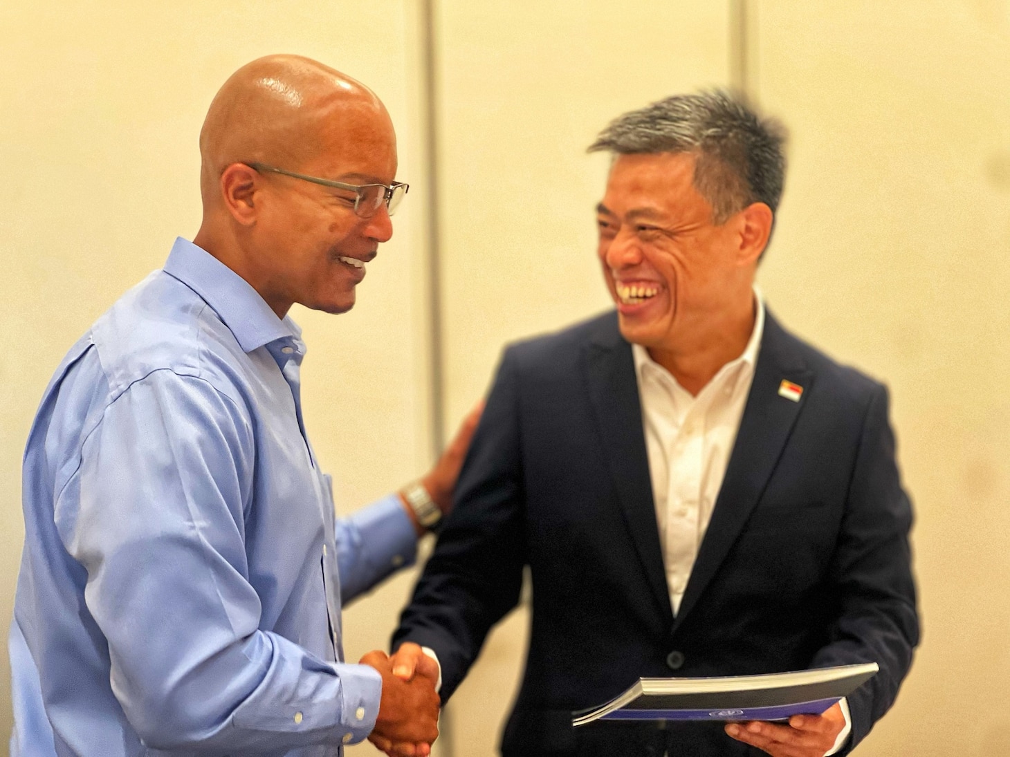 NCIS Directorate Leader shakes hands with Singapore Armed Forces Military Police Col. Low Puay Kng