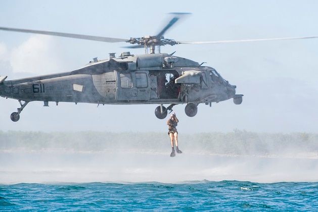 Naval Air Crewman (Helicopter) 3rd Class Jacob Gateman, from Vashon Island, Washington, assigned to the Golden Falcons of Helicopter Sea Combat Squadron (HSC) 12, currently deployed aboard Nimitz-class aircraft carrier USS George Washington (CVN 73), jumps from an MH-60S Seahawk during expeditionary advanced base operations at U.S. Naval Base Guam, Oct. 31, 2024.