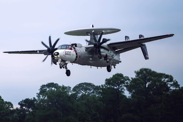 240909-N-N0783-1001 TUCSON, Ariz. – An E-2C Hawkeye aircraft assigned to Airborne Command & Control Squadron (VAW) 123 prepares to land Davis-Monthan Air Force Base, the largest aircraft boneyard in the world in Tucson, in September 2024. VAW-123 transferred two of their four E-2C Hawkeye aircraft to the boneyard. This event was part of the squadron’s transition to the E-2D Advanced Hawkeye to be completed in mid-2025. (Photo courtesy U.S. Navy)