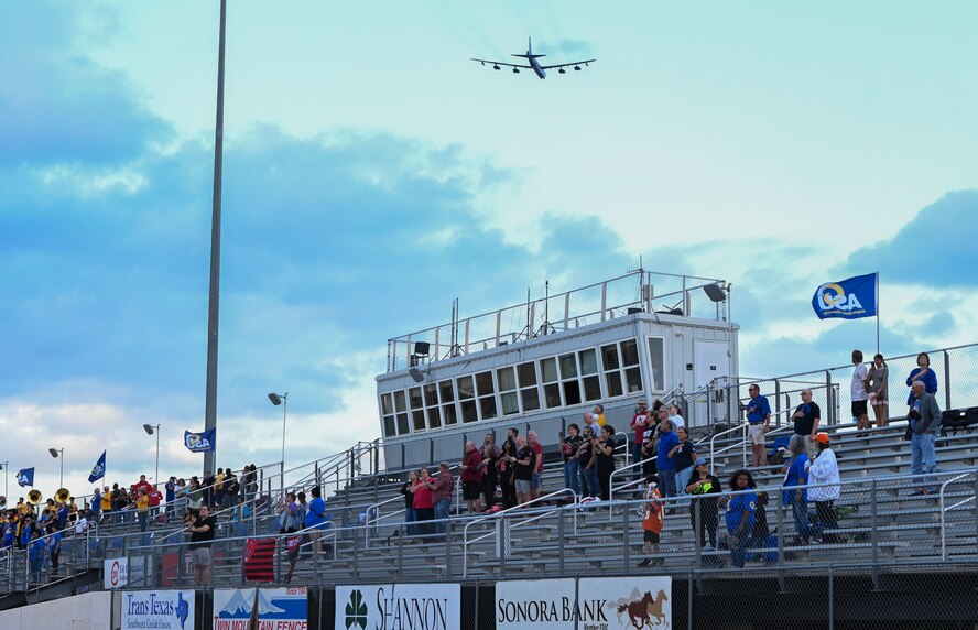 A B-52 Stratofortress, flying from the 69th Bomb Squadron, Minot Air Force Base, flies across the football field as part of the annual Angelo State University Military Appreciation Game at the 1st Community Credit Union Field at LeGrand Stadium, San Angelo, Texas, Nov. 2, 2024. The B-52 is an American long-range, subsonic jet bomber, designed by Boeing and in service with the U.S. Air Force since the 1950s. (U.S. Air Force photo by Airman 1st Class James Salellas)