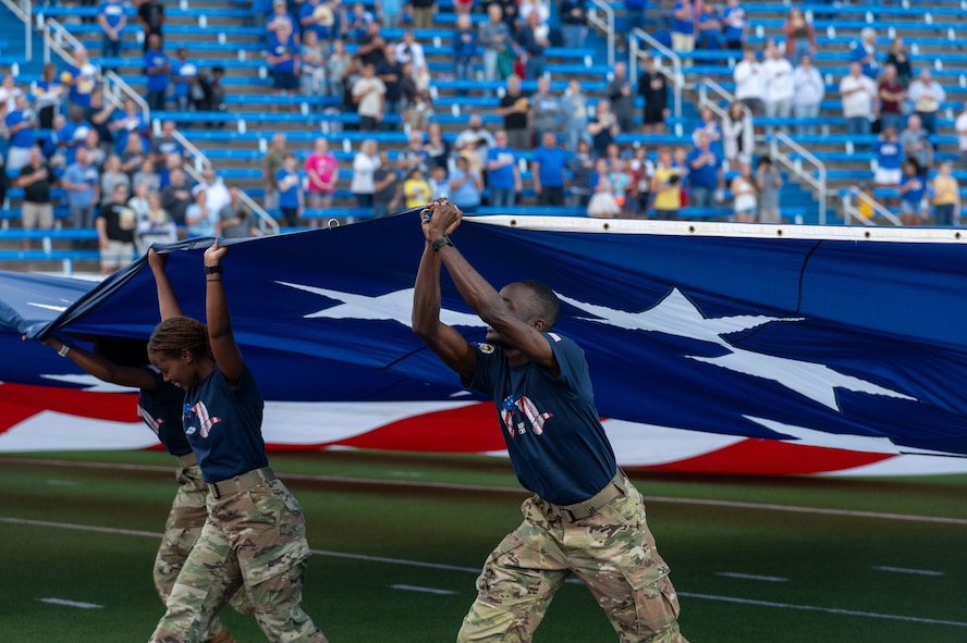 Members of the Angelo State University Air Force ROTC Detachment 847 wave the American flag across the 1st Community Credit Union Field at LeGrand Stadium as part of the annual Angelo State University Military Appreciation Game, San Angelo, Texas, Nov. 2, 2024. The wave of the American flag at the beginning of a game is a symbolic gesture of patriotism, as it highlights the nation’s spirit and honors the country and its history. (U.S. Air Force photo by Airman 1st Class James Salellas)