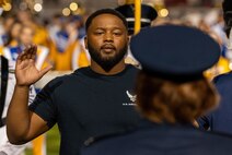 U.S. Air Force Delayed Entry Program recruit recites the oath of enlistment at halftime during the annual Angelo State University Military Appreciation game at the 1st Community Credit Union Field at LeGrand Stadium, San Angelo, Texas, Nov. 2, 2024. The oath of enlistment is a pledge to support the Constitution of the United States.  (U.S. Air Force photo by Airman 1st Class James Salellas)