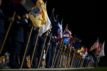 U.S. joint service members bear the U.S. State flags and the Goodfellow Air Force Base Joint Service Color Guard presents each service flag during the halftime show of the Angelo State University Military Appreciation Game at the 1st Community Credit Union Field at LeGrand Stadium, San Angelo, Texas, Nov. 2, 2024. During the halftime show, the ASU Ram Band played through each service song to honor those who have served. (U.S. Air Force photo by Airman 1st Class Madi Collier)