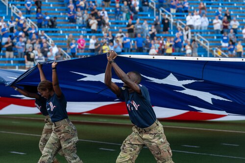 Members of the Angelo State University Air Force ROTC Detachment 847 wave the American flag across the 1st Community Credit Union Field at LeGrand Stadium as part of the annual Angelo State University Military Appreciation Game, San Angelo, Texas, Nov. 2, 2024. The wave of the American flag at the beginning of a game is a symbolic gesture of patriotism, as it highlights the nation’s spirit and honors the country and its history. (U.S. Air Force photo by Airman 1st Class James Salellas)