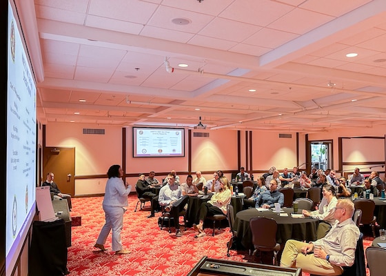 SAN DIEGO (Oct. 29, 2024) – Capt. Marcy Morlock, Navy Medicine Readiness and Training Command (NMRTC) San Diego and Naval Medical Center San Diego’s (NMCSD) executive officer, speaks to  the leadership team during an executive planning conference at Marine Corps Air Station (MCAS) Miramar Officer’s Club. NMCSD’s mission is to prepare service members to deploy in support of operational forces, deliver high quality healthcare services and shape the future of military medicine through education, training and research. NMCSD employs more than 5,000 active duty military personnel, civilians and contractors in Southern California to provide patients with world-class care anytime, anywhere. (U.S. Navy photo by Mass Communication Specialist 1st Class James R. Mitchell)