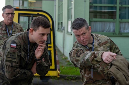 U.S. Air Force Master Sgt. Jaron Bridges, 126th Logistics Readiness Squadron, points to pallets stacked up at the 8th Airlift Base, Krakow, Poland, Oct. 21, 2024. The 126th LRS was in Poland as part of an expeditionary site survey of Polish bases to assess their capabilities and runway strength for use by U.S., allied and partner forces.