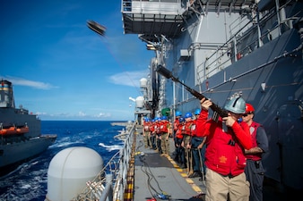 Lt. Cmdr. Brian Sorge fires a shot line from USS Boxer (LHD 4) to USNS Yukon (T-AO 202) in the Pacific Ocean.