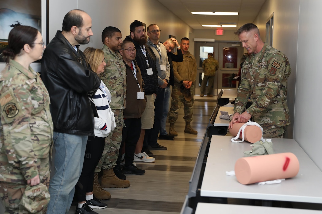 Master Sgt. Todd Ryan, 445th Aeromedical Staging Squadron tactical combat casualty care program director, applies a pressure bandage to a mock patient during TCCC demonstration for employers participating in the 445th Airlift Wing Employer Appreciation Day Nov. 2, 2024. The wing hosted more than 40 employers, giving them the opportunity to learn about the wing’s operations and concluded with a flight on a C-17 Globemaster III. (U.S Air Force photo/Senior Airman Angela Jackson)