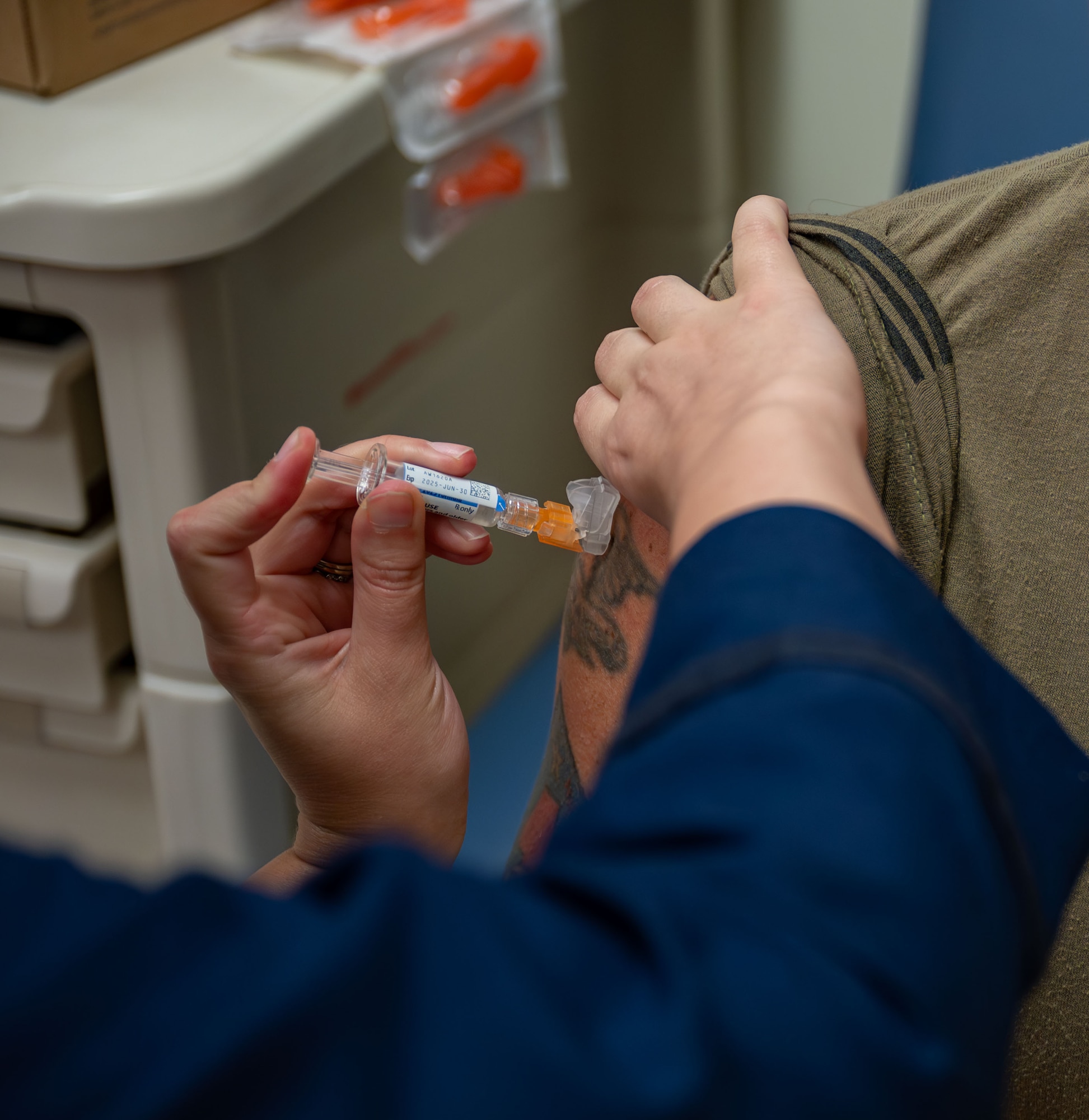 A 920th Aeromedical Staging Squadron clinical nurse, administers a dose of the influenza vaccine to a 920th Rescue Wing Airman